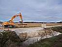 01.jpg: Backhoe prepared for arrival of the culvert