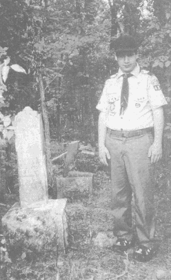 Glen Martin, 17, of Boy Scout Troop 487 (posing by a Brown family gravestone)